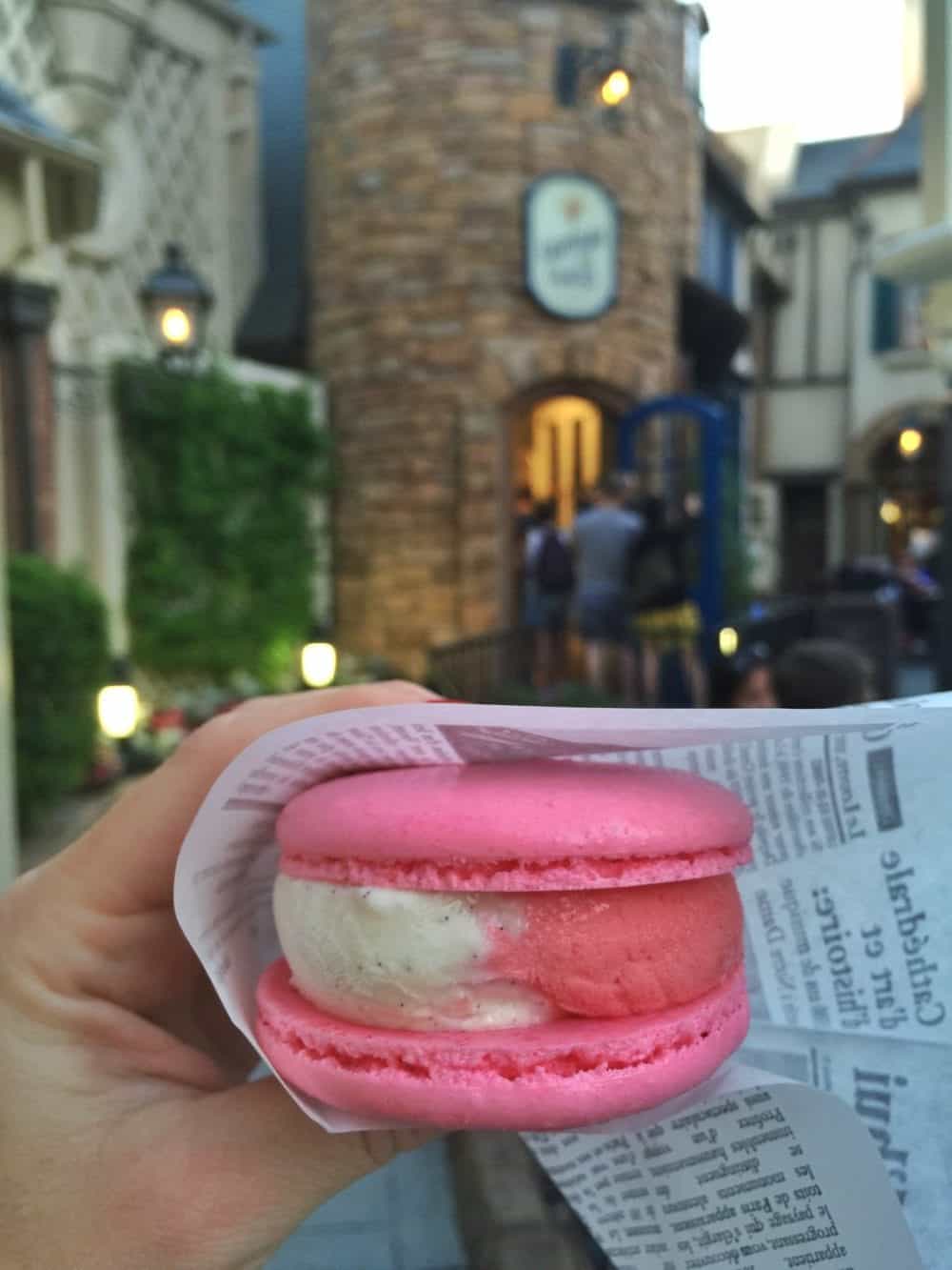 A Pink Macaron Ice Cream Sandwich with Pink and White Ice Cream Inside