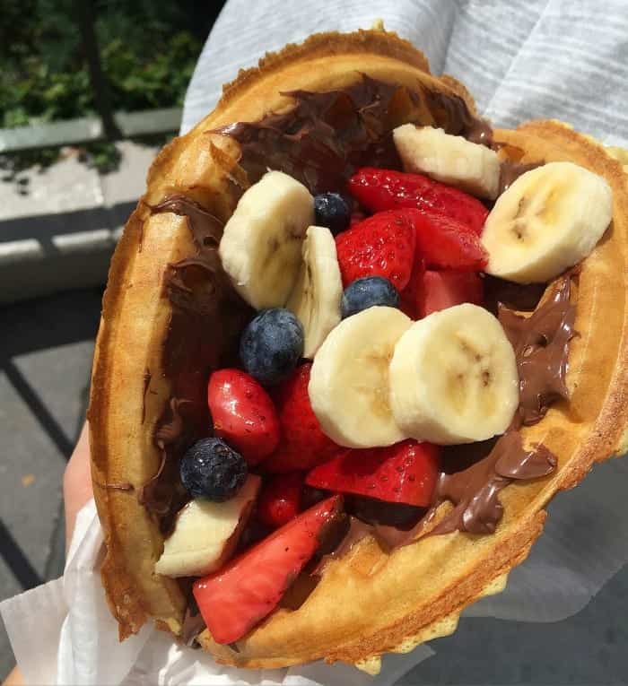 A Waffle Sandwich Filled with Berries, Bananas and Chocolate Hazelnut Spread