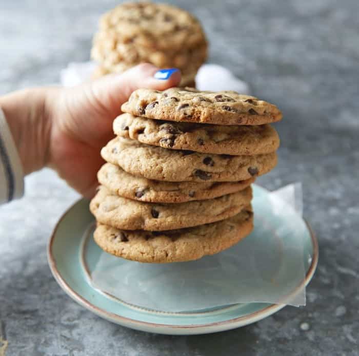 A Hand Holding a Stack of Six Reese's Chocolate Chip Cookies