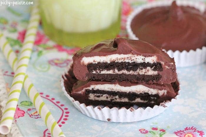 Two halves of Chocolate Oreo buttercream cups stacked to reveal the Oreo centers.