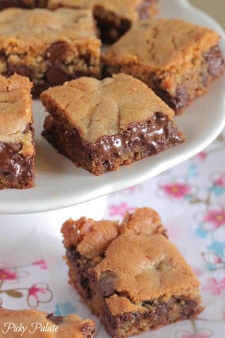 Vanilla malted chocolate chip cookie bars on a cake stand.