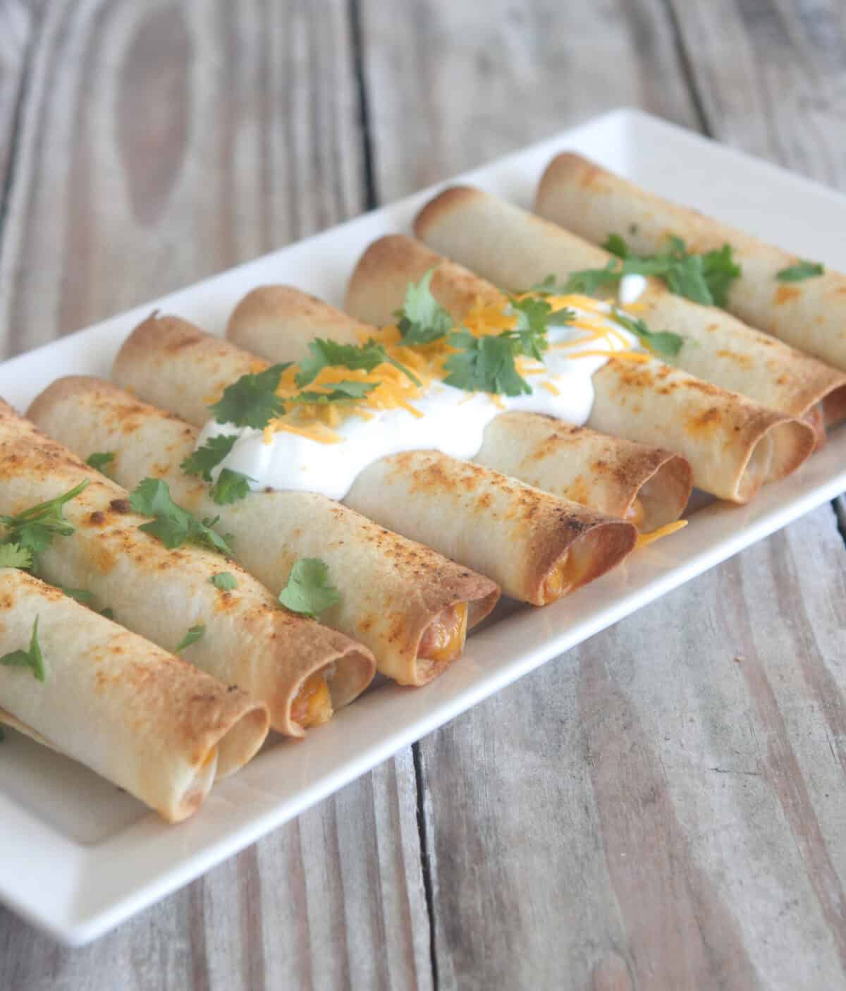 bean and cheese taquitos on serving plate