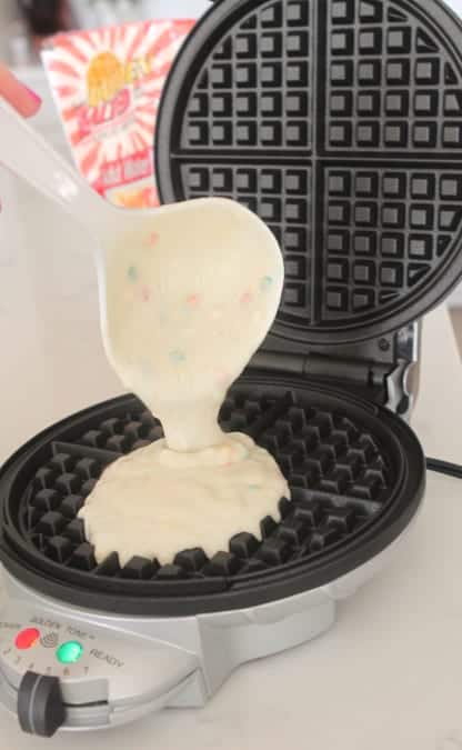 Birthday Cake Waffle Batter Being Poured Into a Waffle Maker