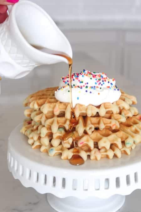 Four Funfetti Waffles Topped with Whipped Cream and Rainbow Sprinkles