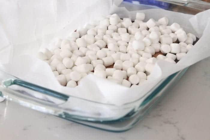 marshmallows in pan before brownie batter is poured in for Oreo S'mores Brownies.