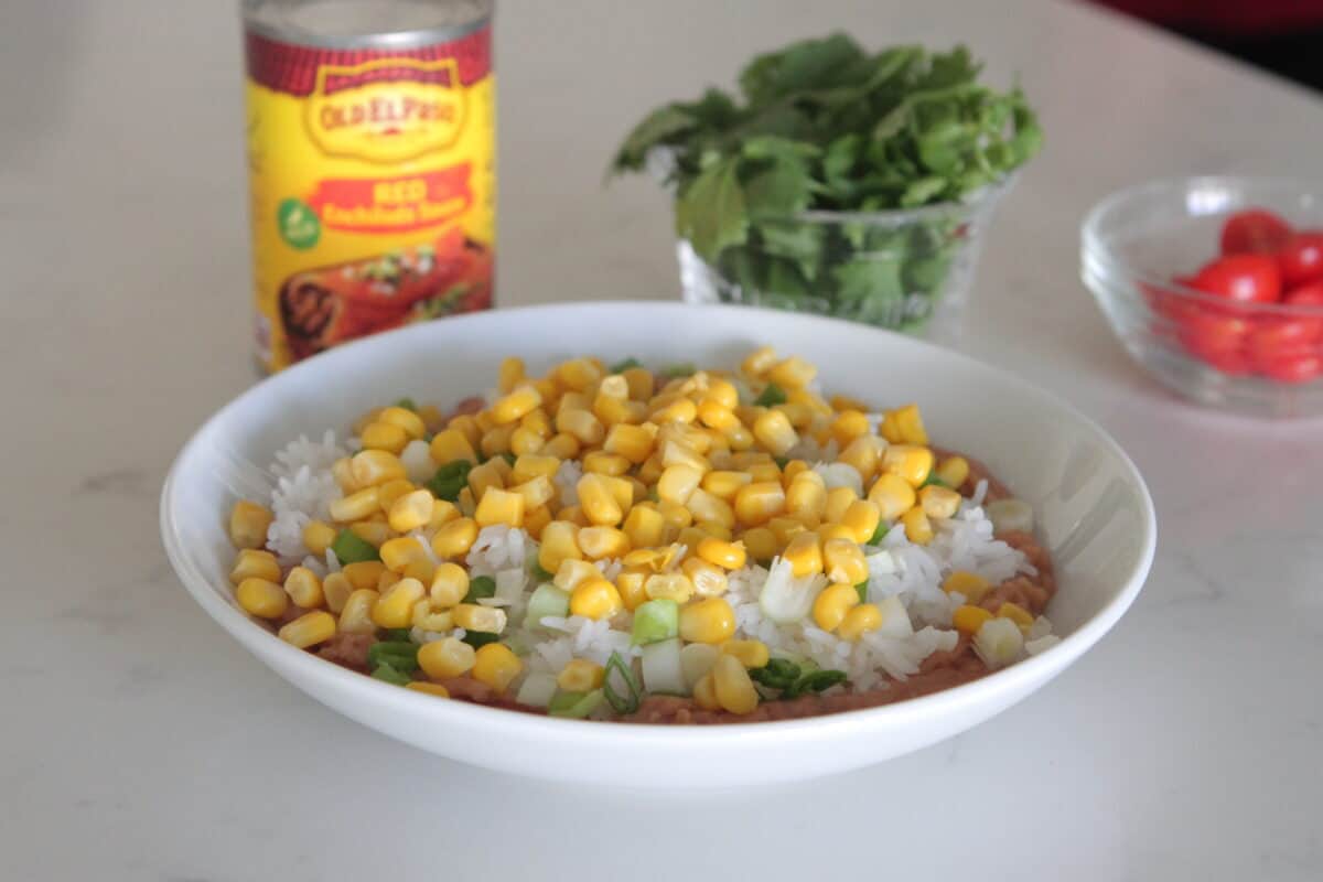 corn layered on enchilada bowls