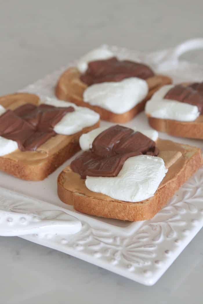 Four slices of S'mores Peanut Butter Toast on a serving platter.