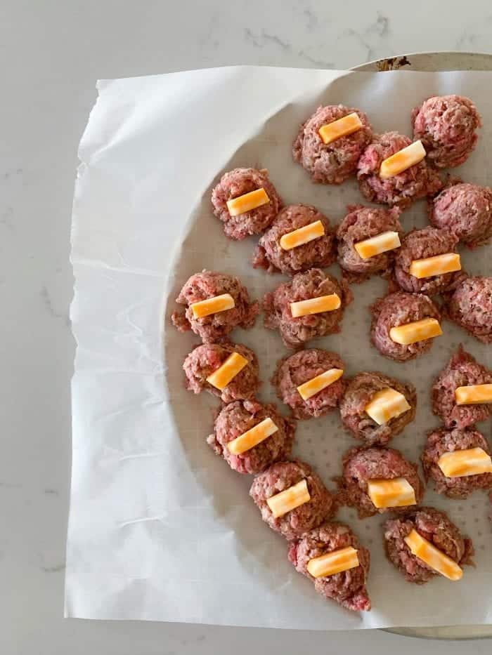 add cheese to middle of meatballs