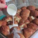 drizzling icing over cinnamon roll bubble bites