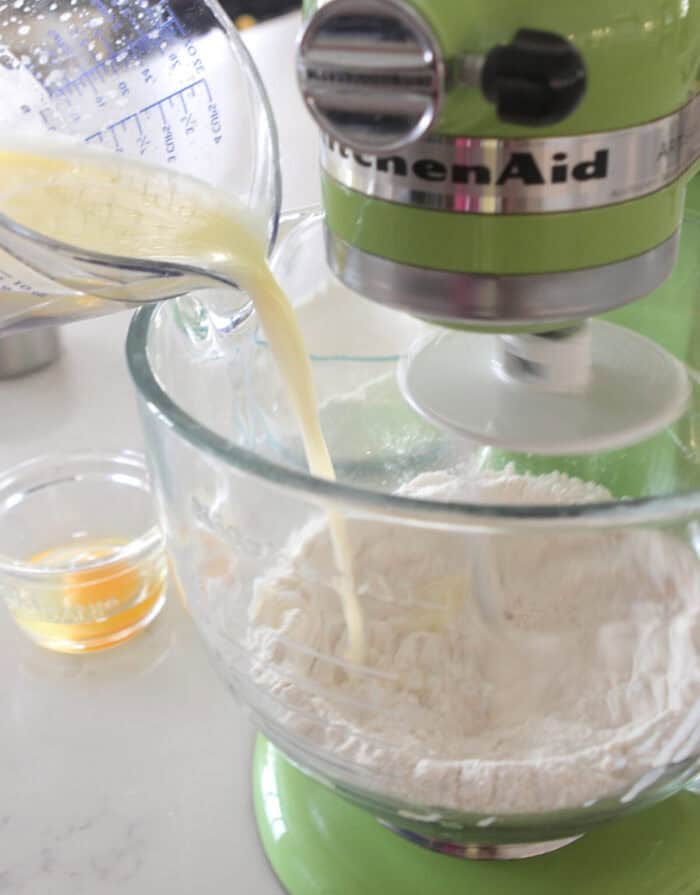 pouring melted butter mixture to stand mixer 