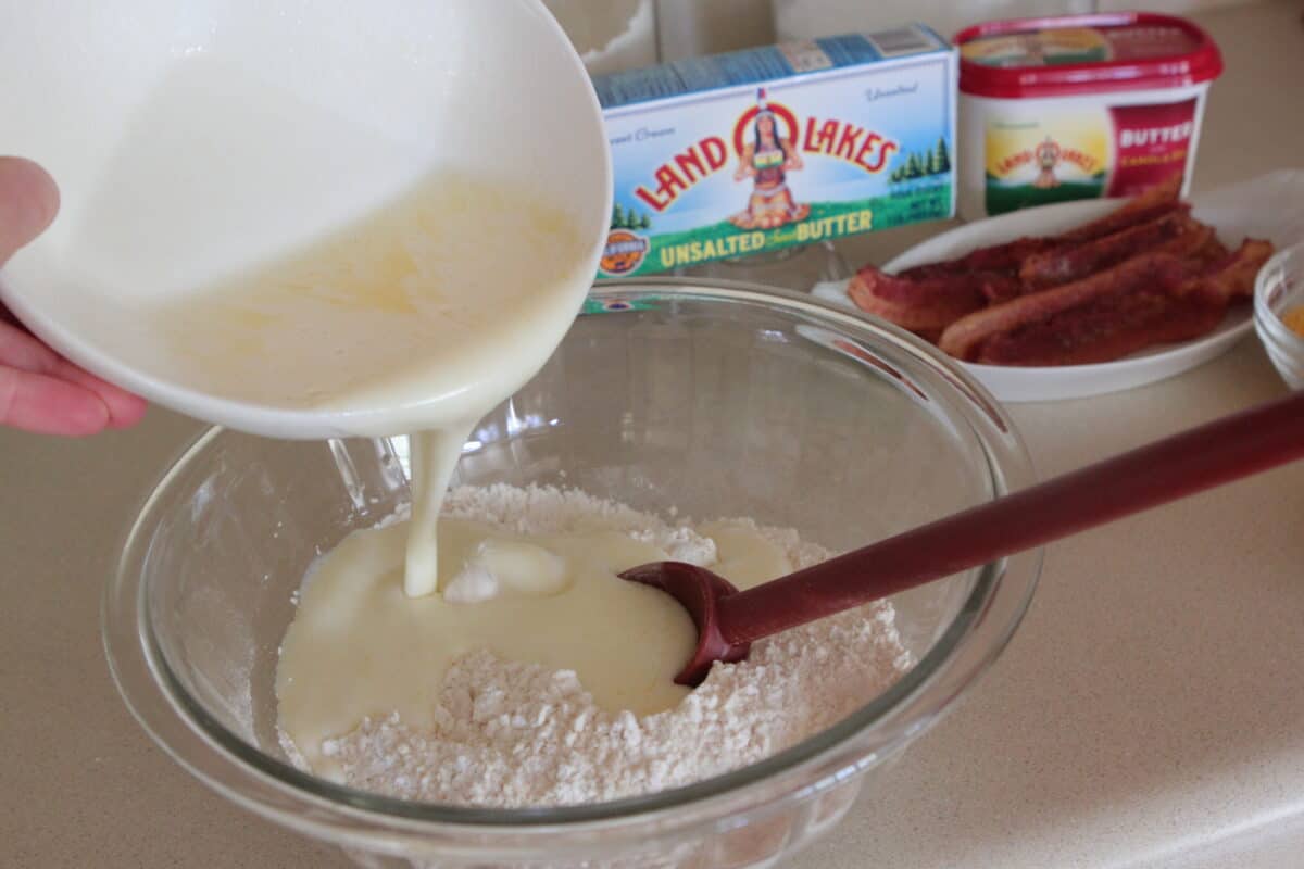 pouring buttermilk into dry ingredient bowl