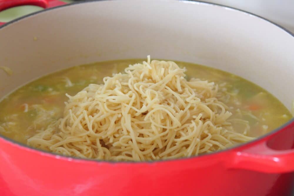 add cooked noodles to pot of chicken noodle soup
