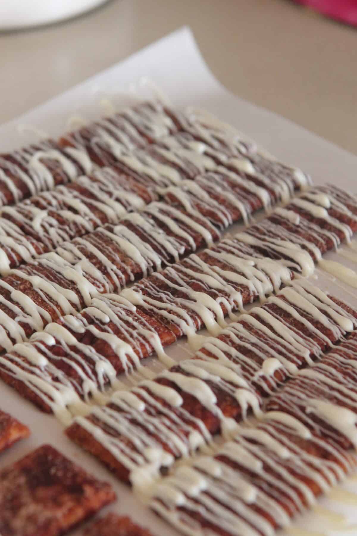 white chocolate drizzled over crack crackers