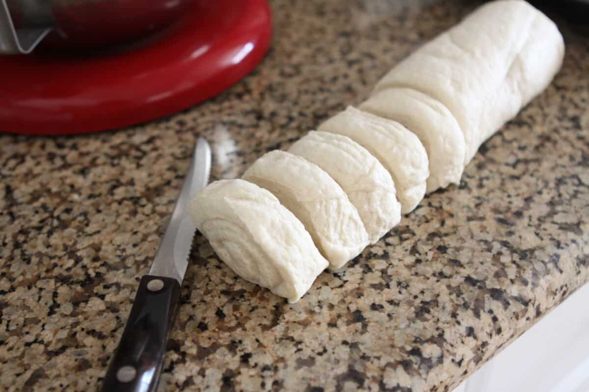 slicing refrigerated dough on counter