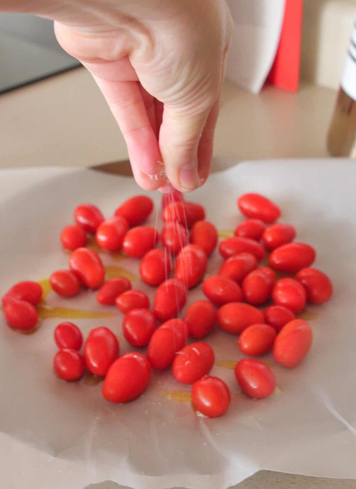 seasoning cherry tomatoes on baking dish