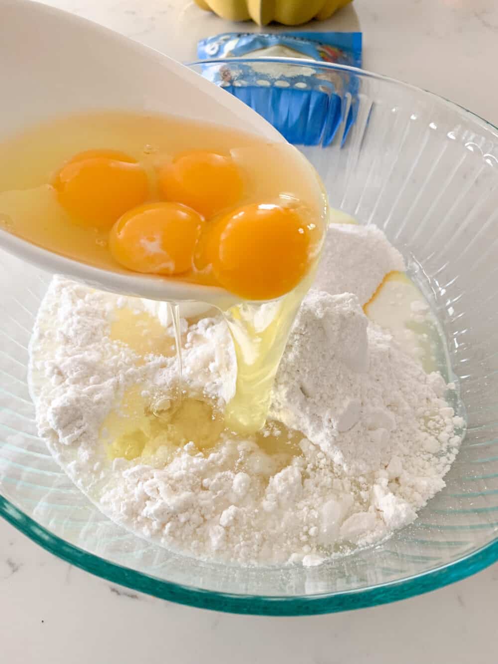 pouring eggs in mixing bowl