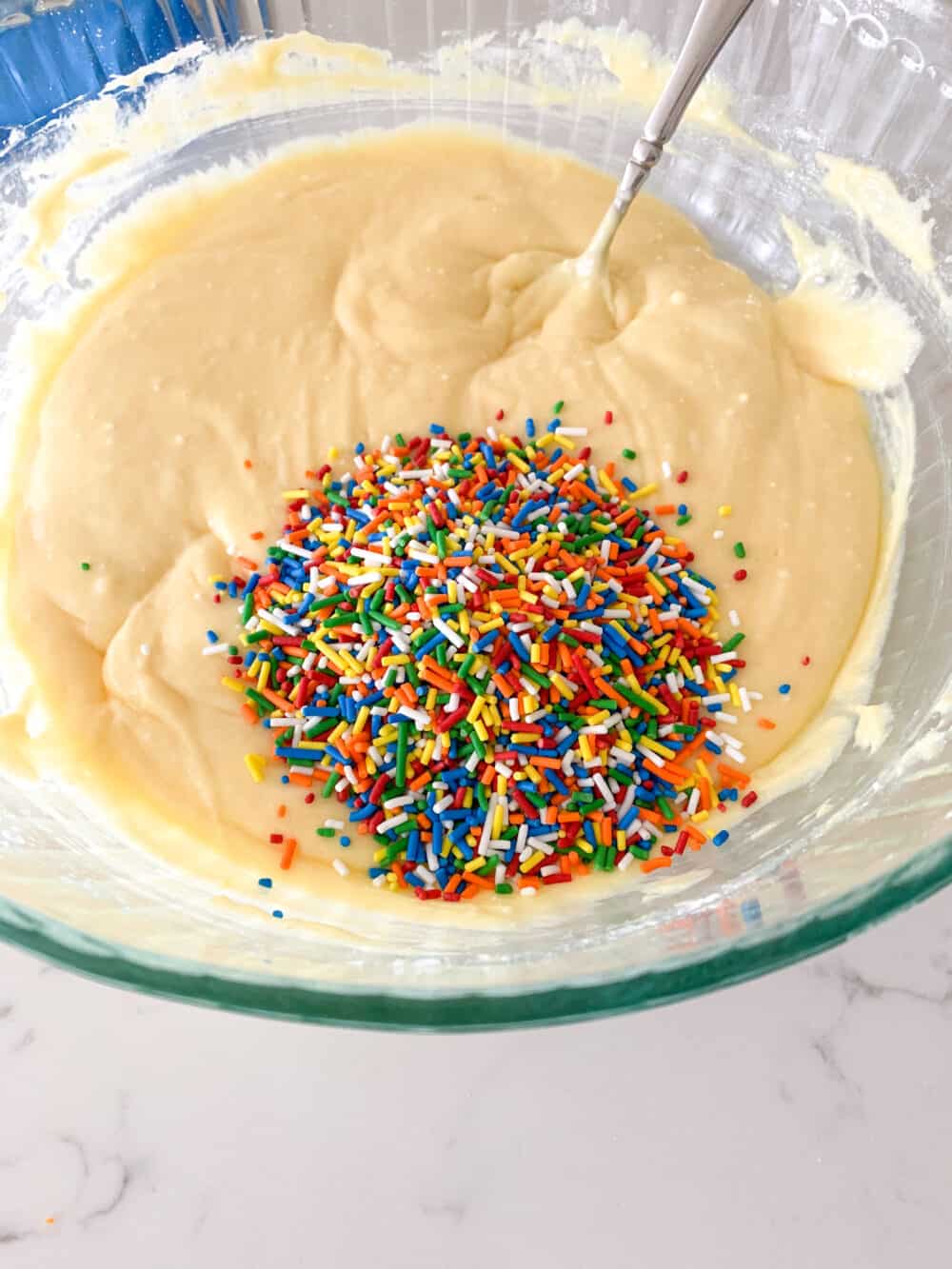 sprinkles in cake batter in mixing bowl