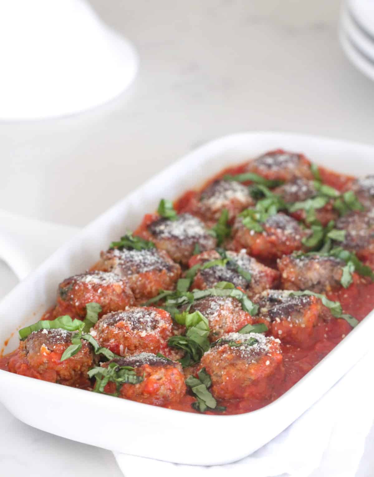 homemade meatballs in pasta sauce on serving dish