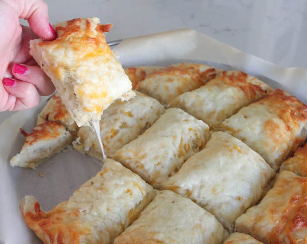 showing cheese pull of pizza bread