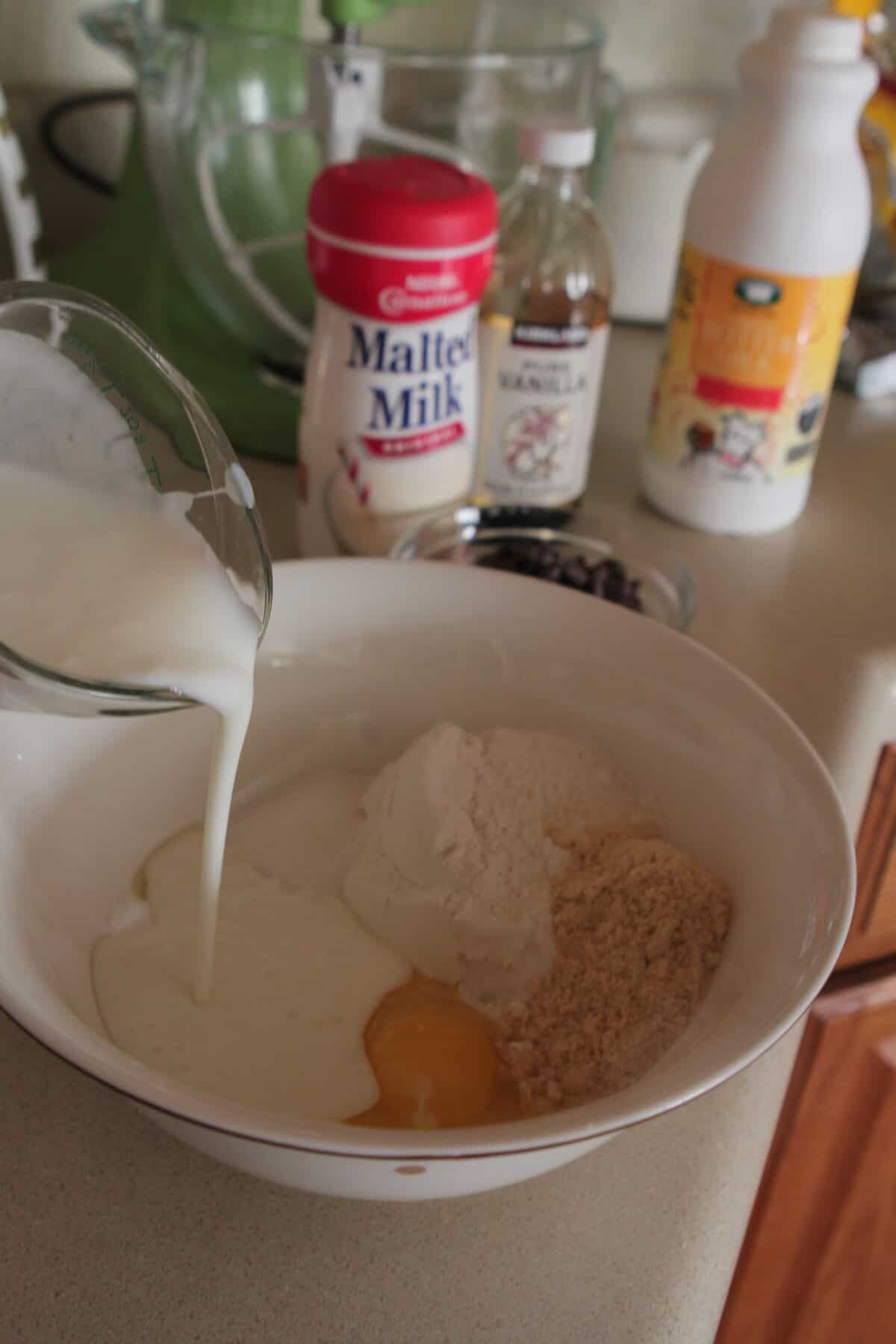 pouring buttermilk to mixing bowl for pancakes