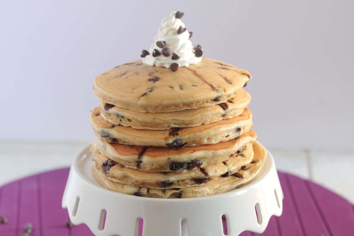 chocolate chip pancakes stacked on cake stand