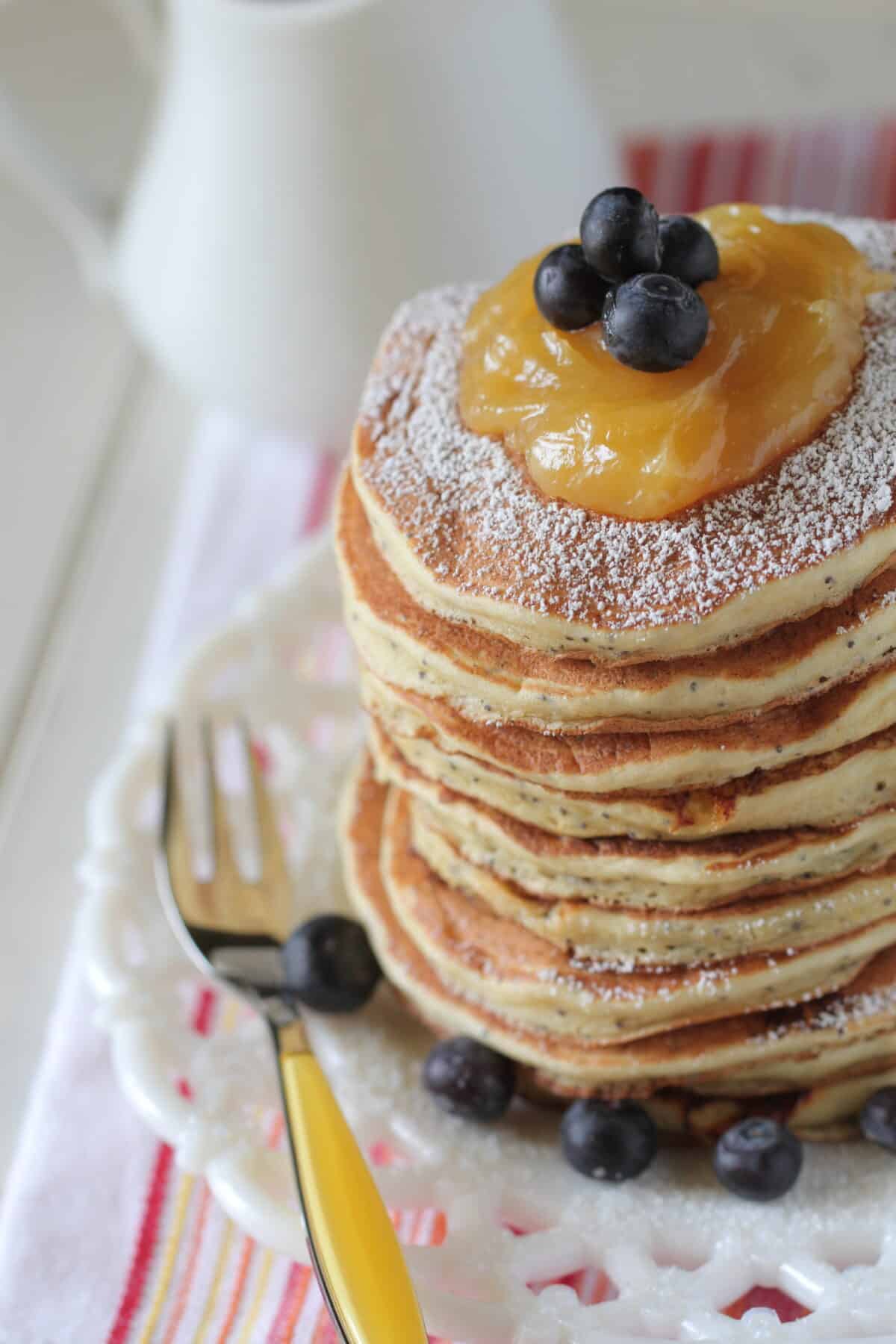 lemon ricotta pancakes stacked on plate