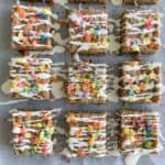 fruity pebbles cookie bars cut into squares on parchment paper
