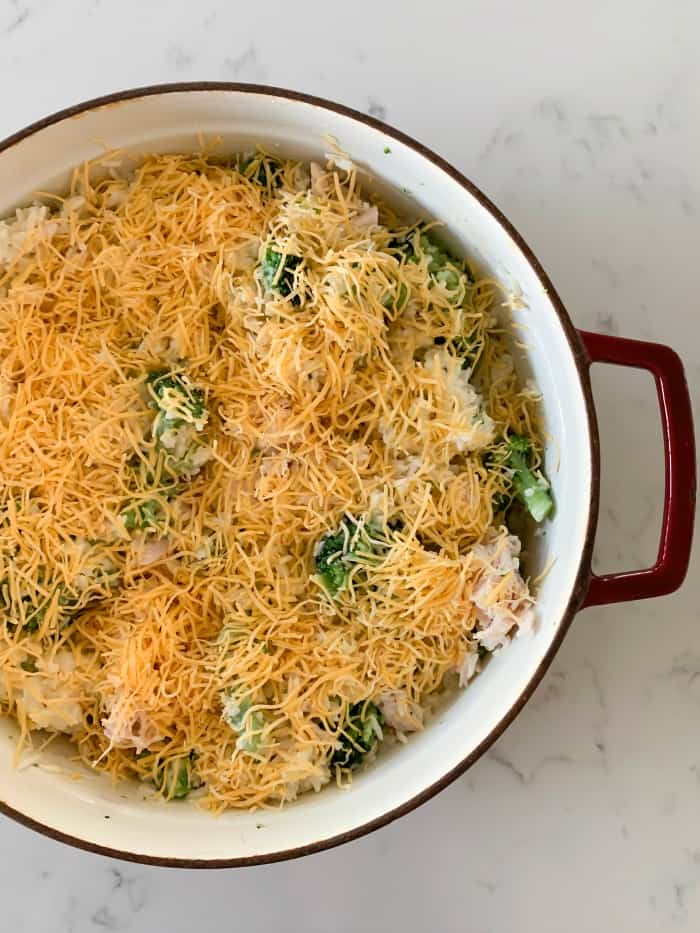 topping casserole with shredded cheese