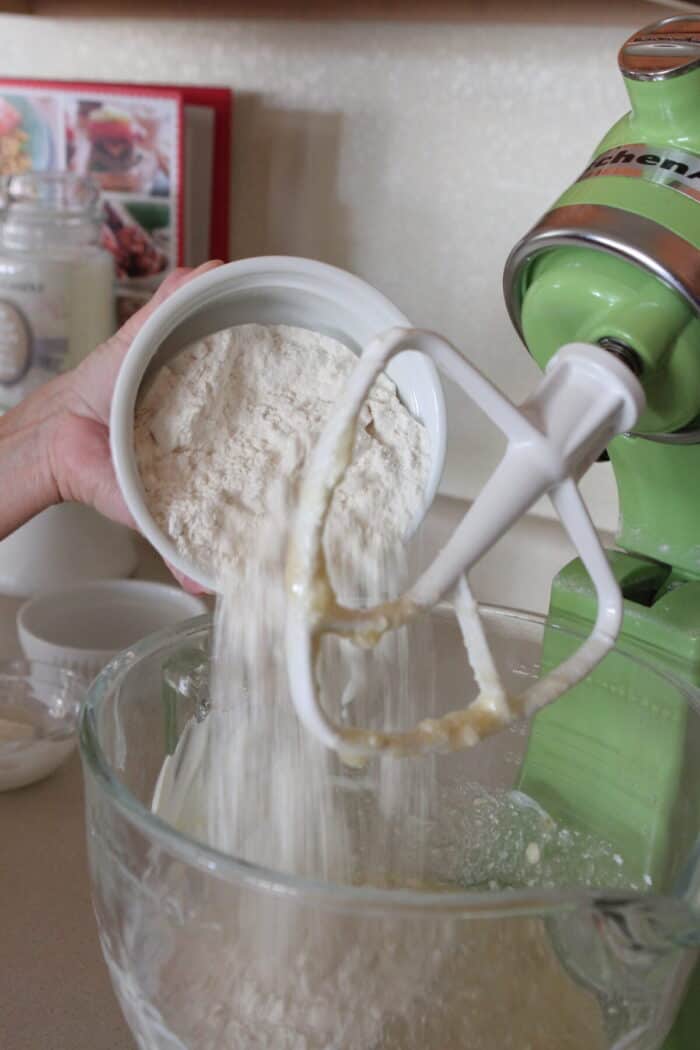 adding flour to stand mixer for banana cake