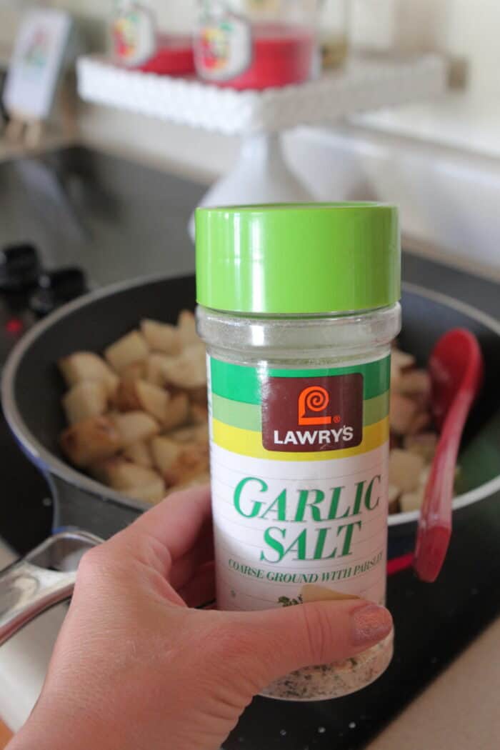 holding lawry's garlic salt to add to potatoes