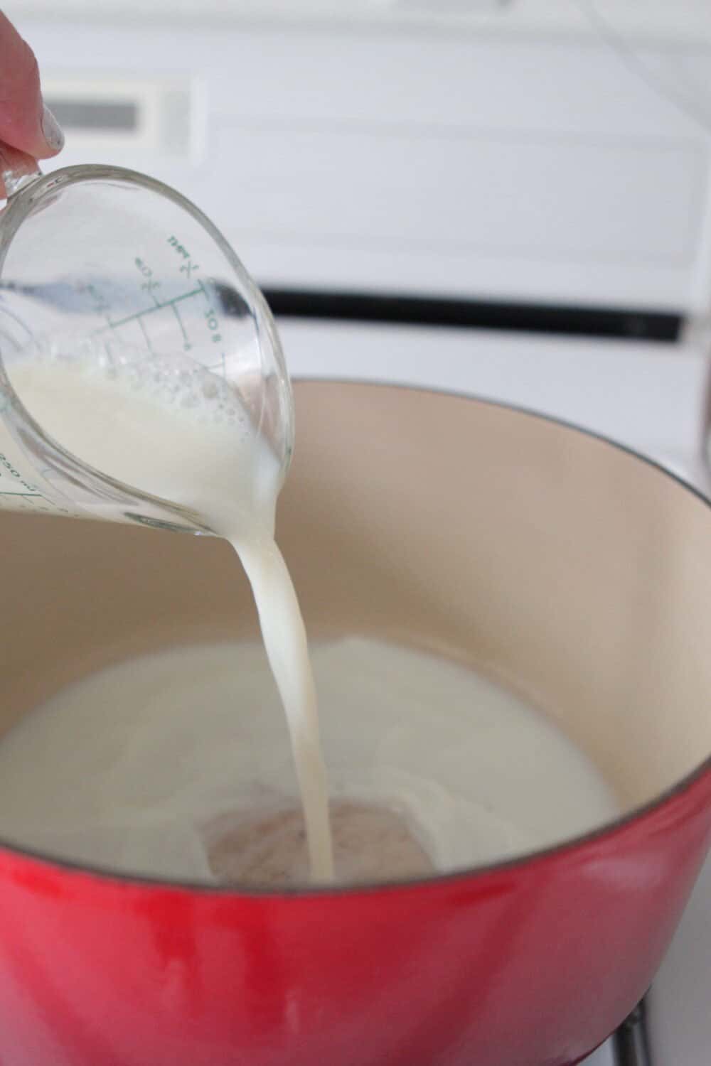 pouring milk into large pan