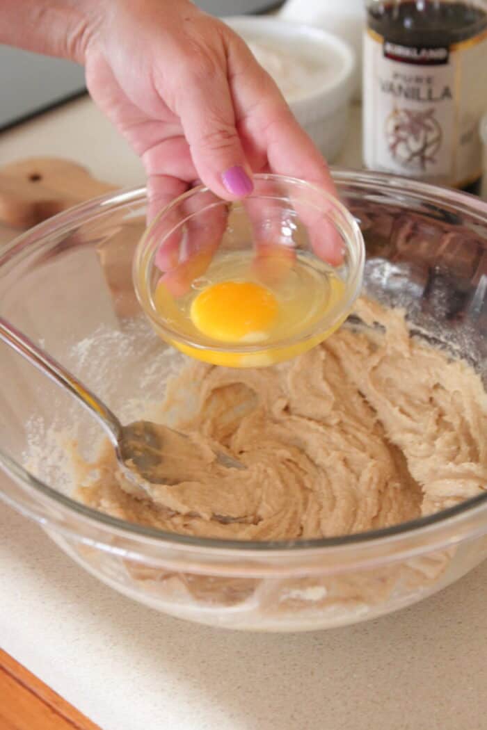 adding egg to mixing bowl for skillet cookie