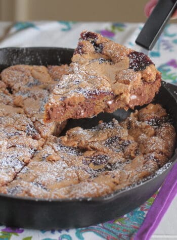 peanut butter and jelly skillet cookie cut into wedges