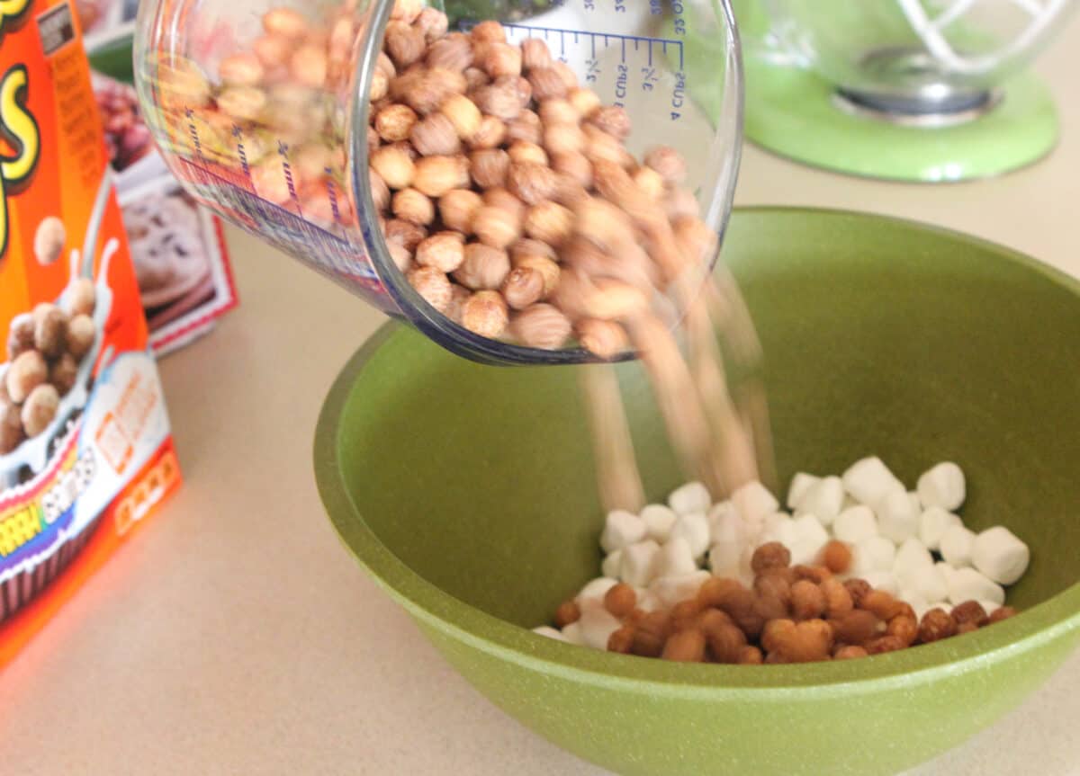 pouring cereal into large mixing bowl 