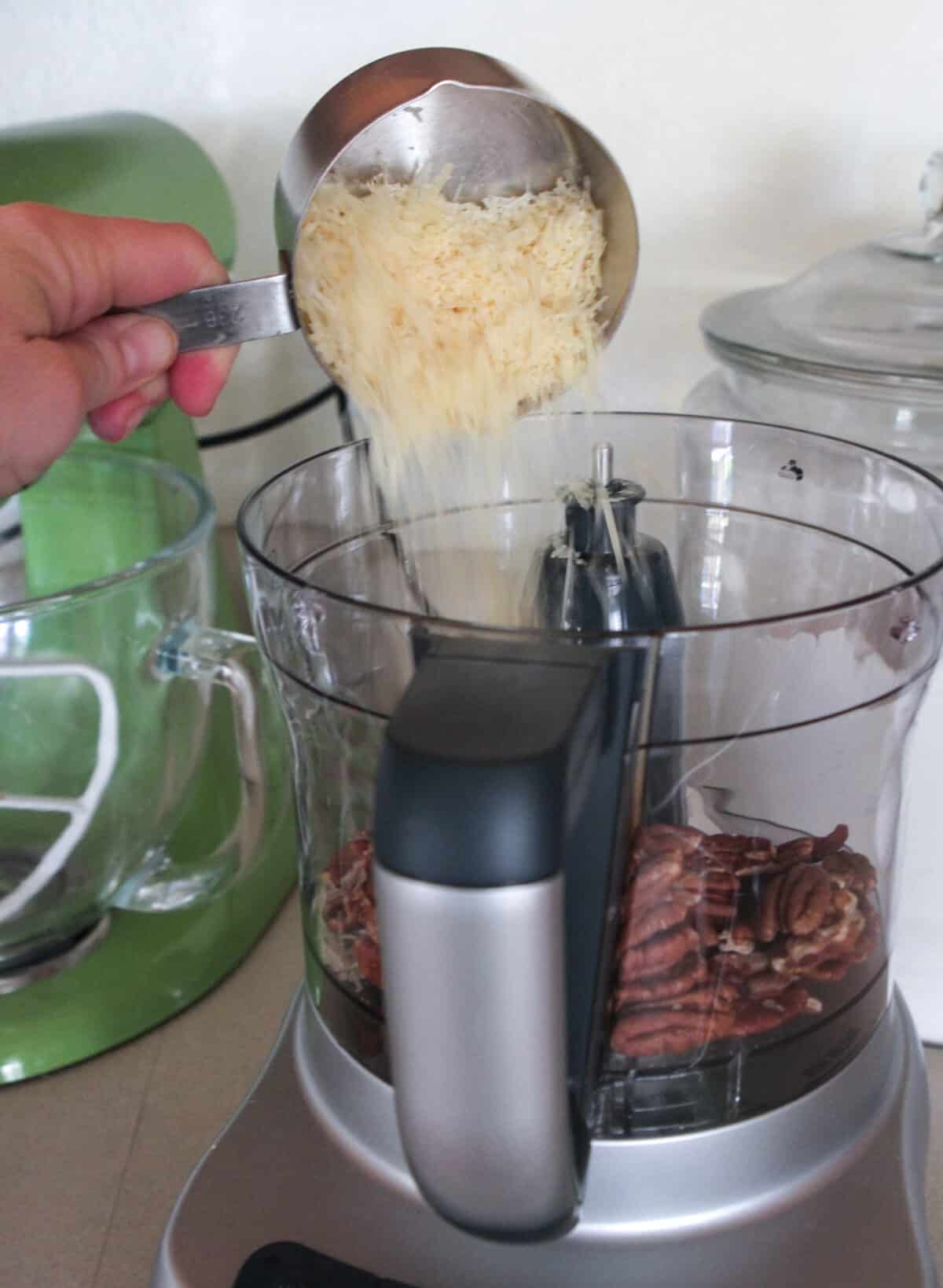 adding parmesan cheese to food processor