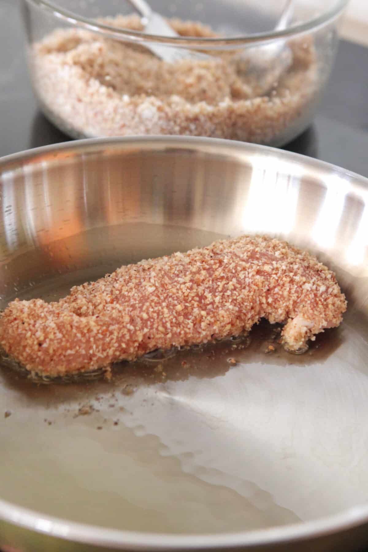 chicken tender cooking in saute pan