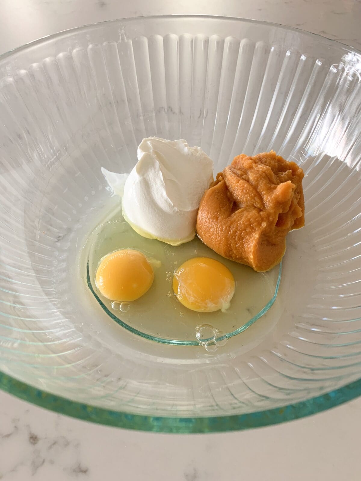 wet ingredients for pumpkin muffin recipe in mixing bowl