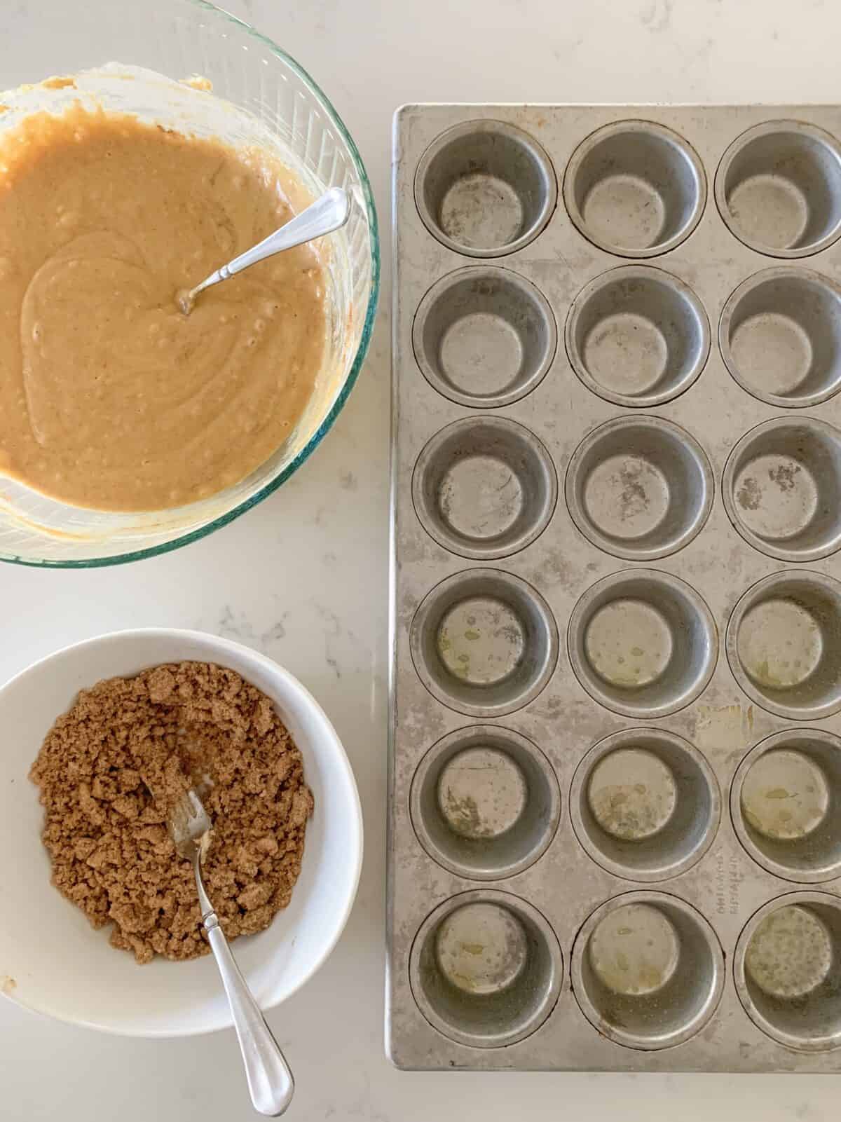 muffin tin plus muffin ingredients in bowl ready to fill cups