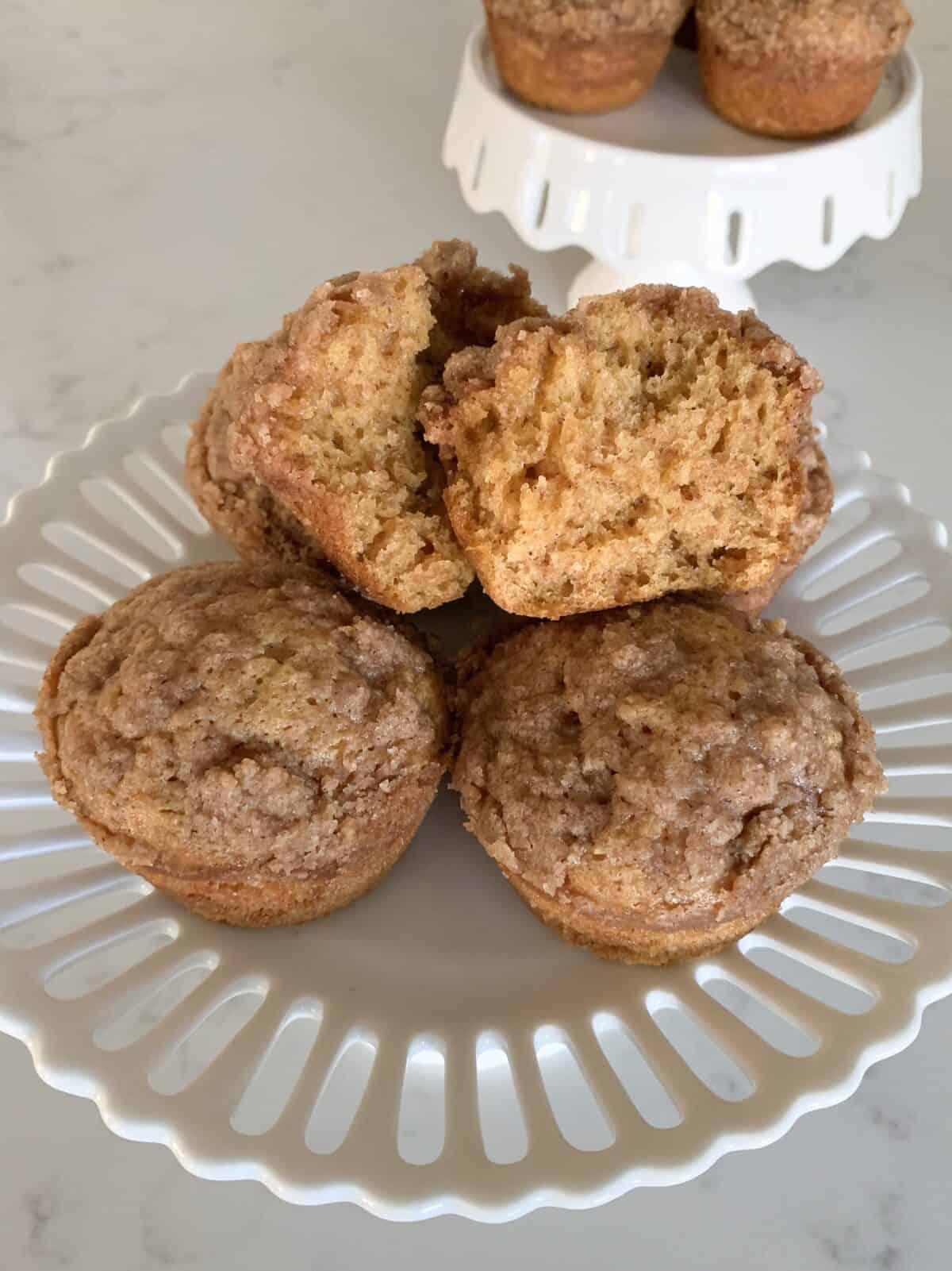 pumpkin muffin cut in half on cake stand
