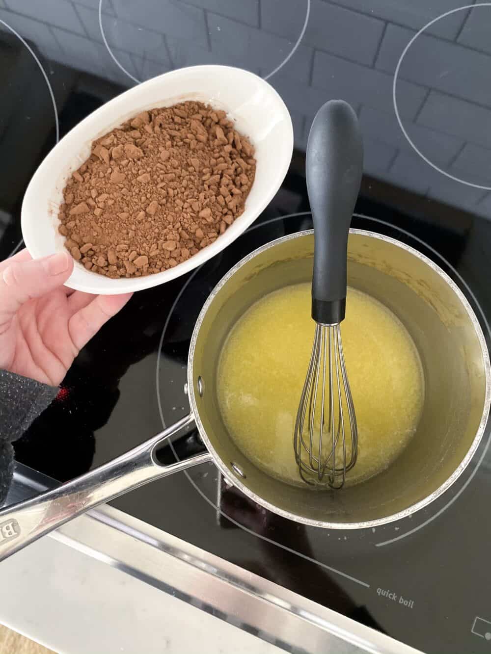 melting butter and cocoa powder for homemade chocolate frosting