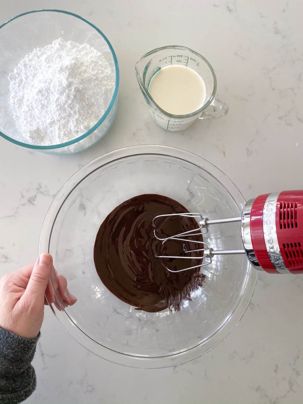 whisking homemade chocolate frosting