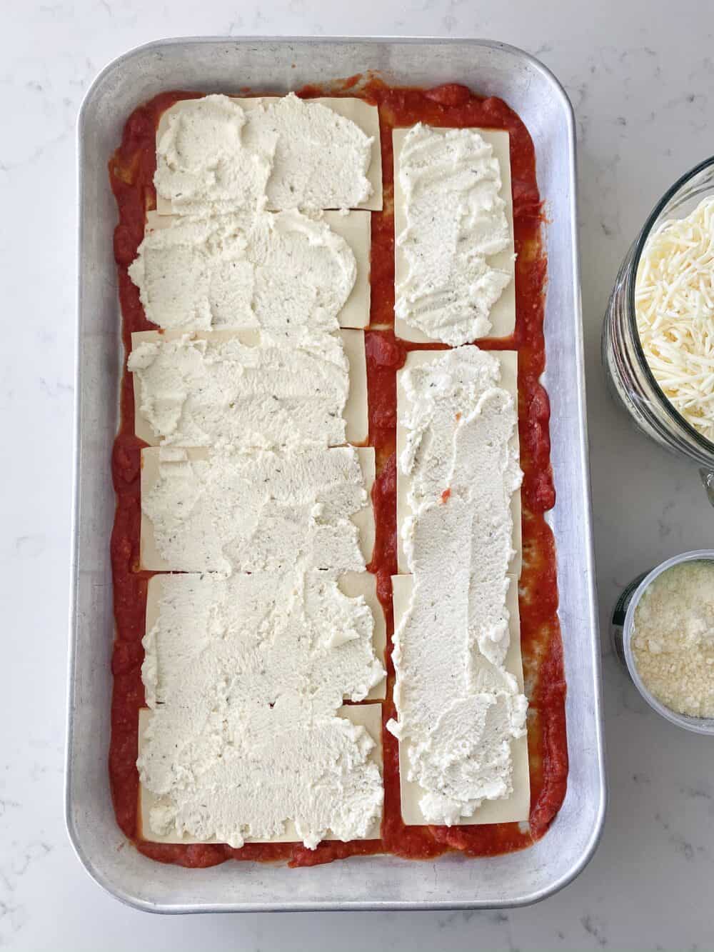 layering ricotta for easy lasagna recipe