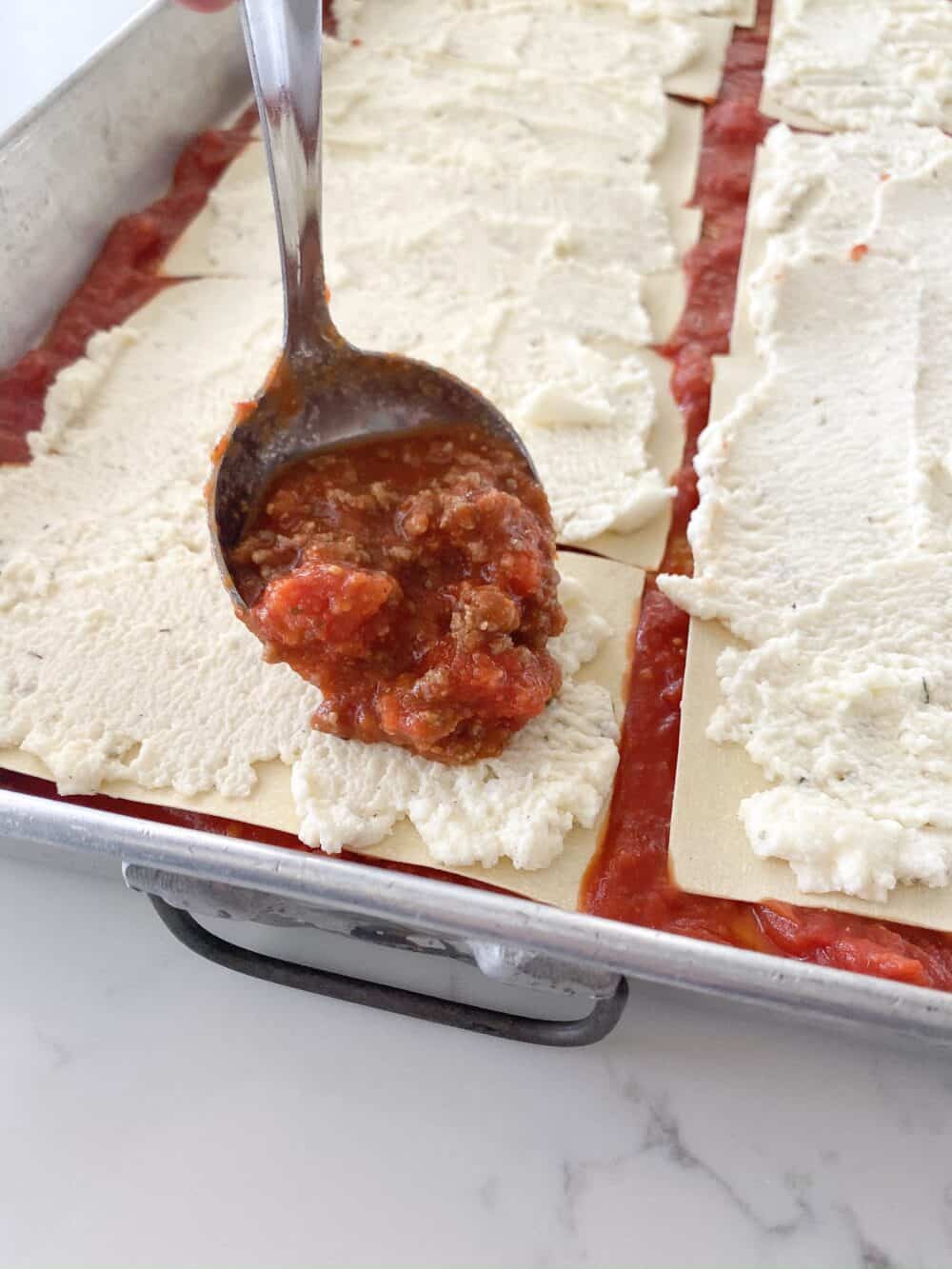 layering meat sauce for easy lasagna recipe