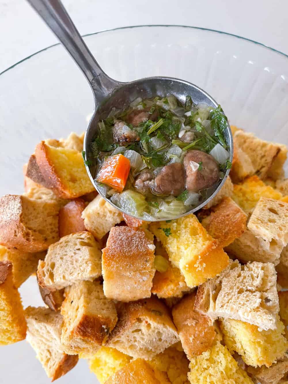 adding broth to toasted bread cubes for thanksgiving stuffing