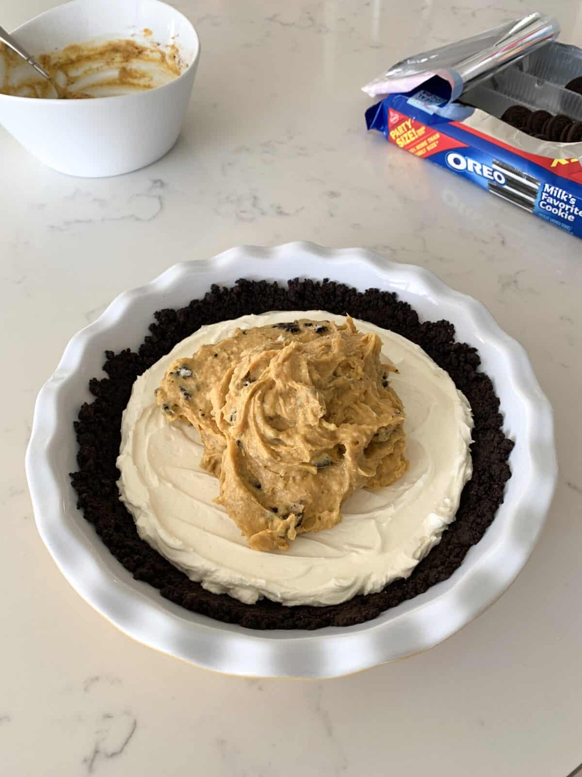 preparing no bake cheesecake in pie plate