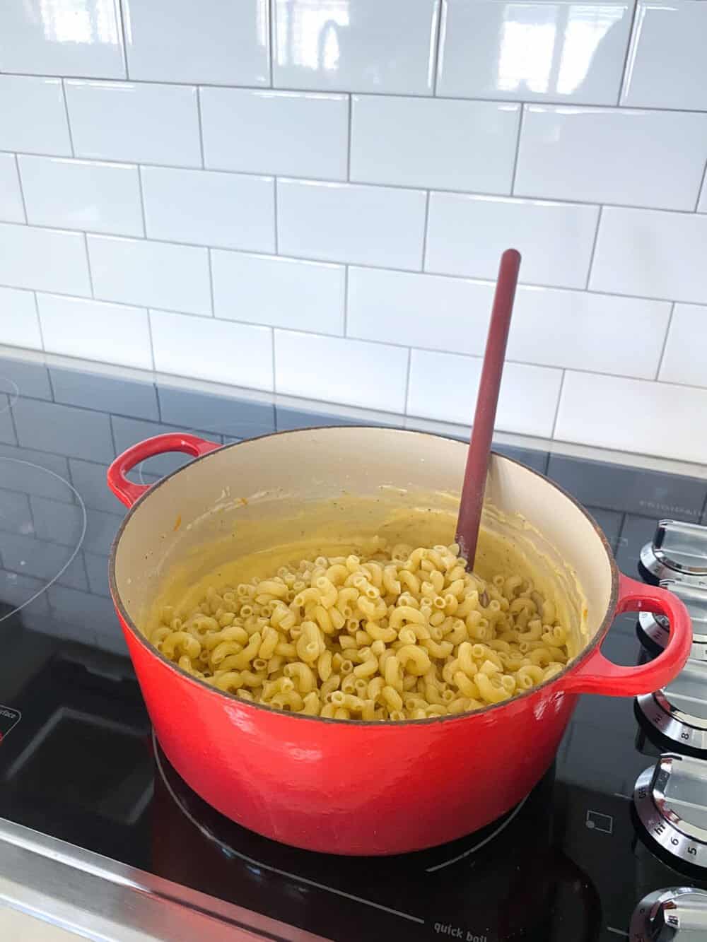 add cooked pasta to sauce for homemade mac and cheese