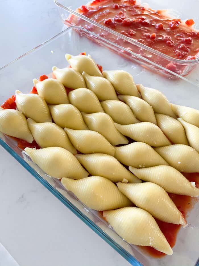 a baking dish full of stuffed pasta shells ready to be cooked
