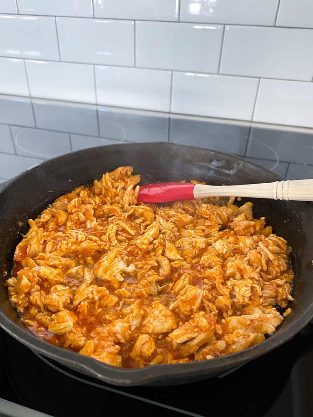 buffalo chicken cooking in skillet