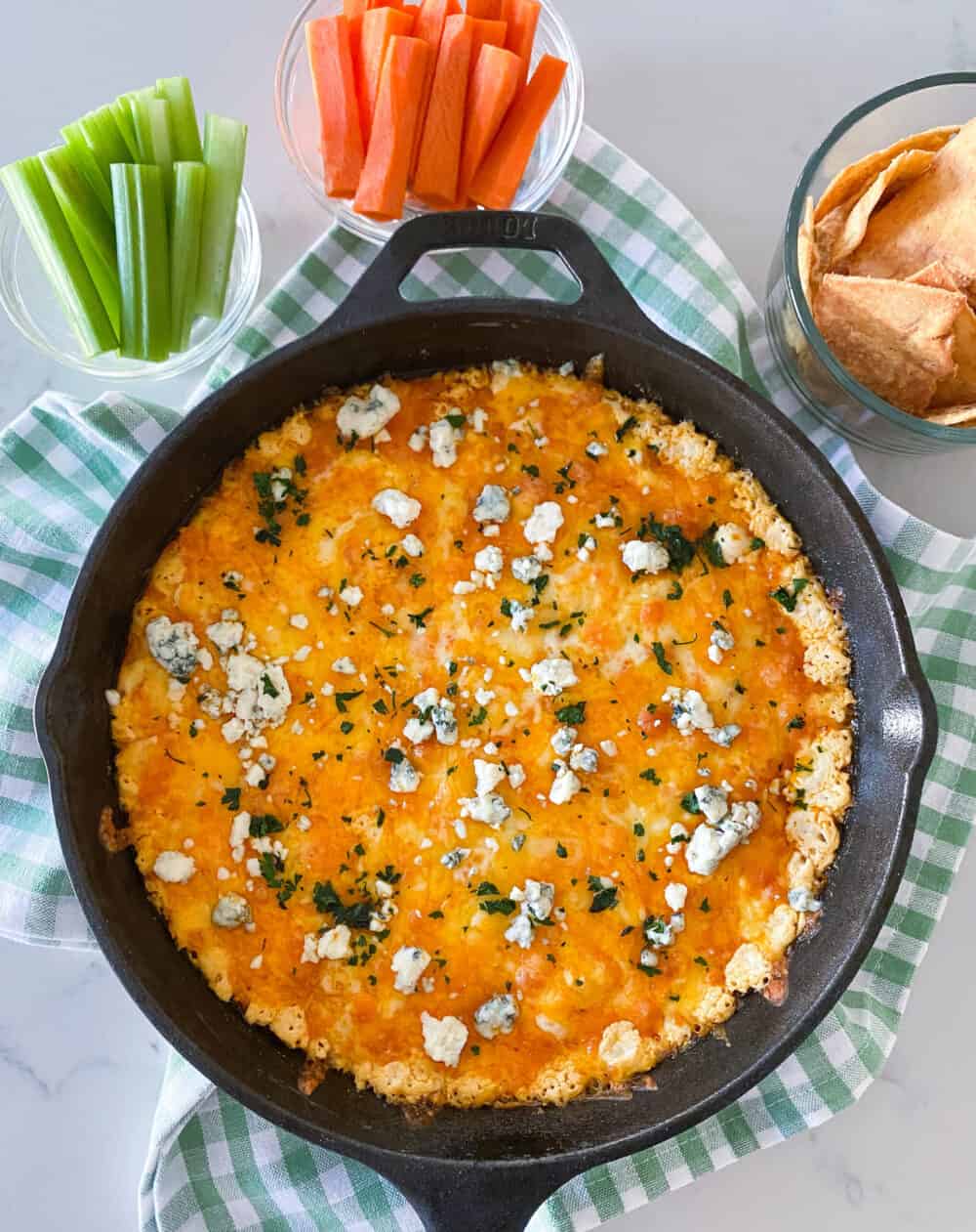 adding blue cheese to top of buffalo chicken dip