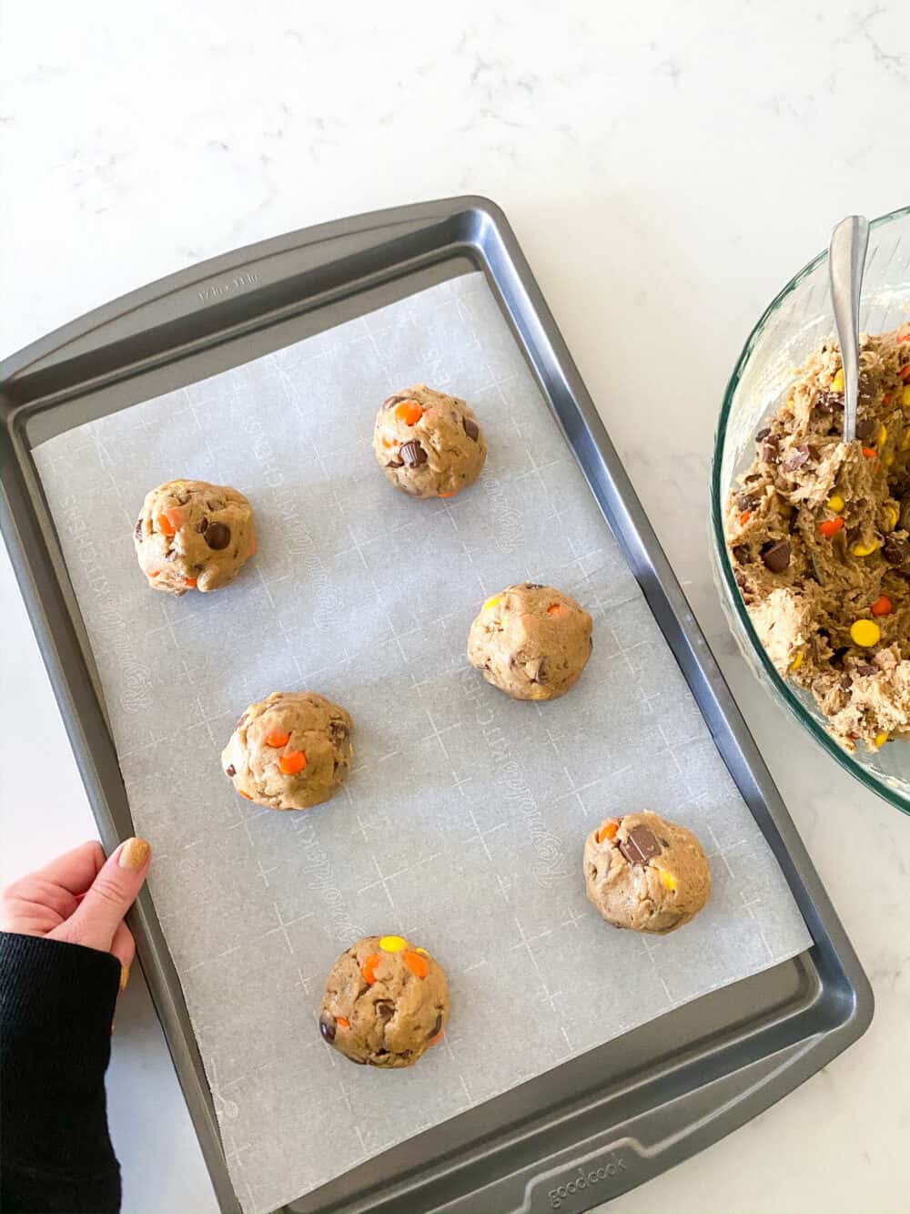 scoops of monster cookies on baking sheet